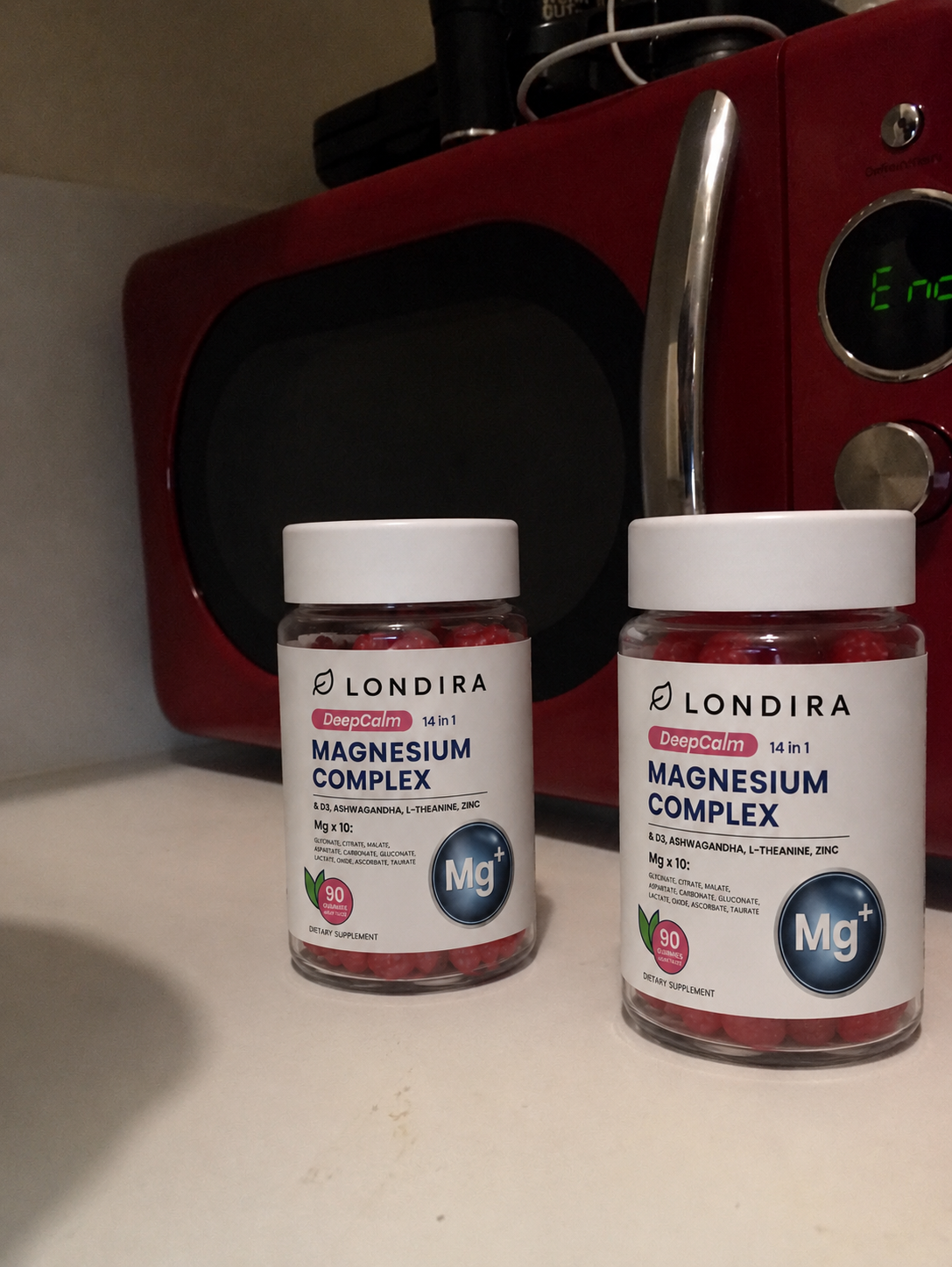 Two jars of Londira magnesium gummies in a kitchen